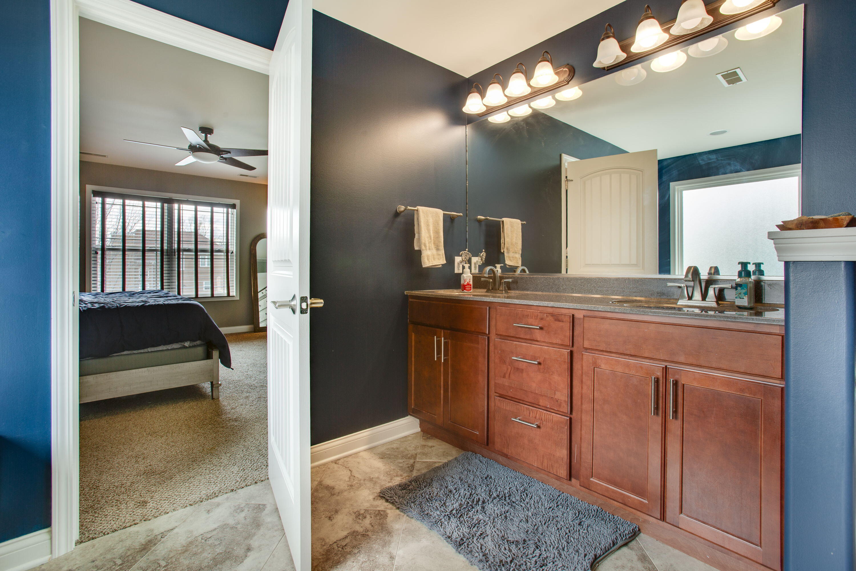 3352 Field Hawk Drive Valparaiso, IN 46383 - Photo 8 of 17 a spacious bathroom with a granite countertop sink a toilet and a mirror