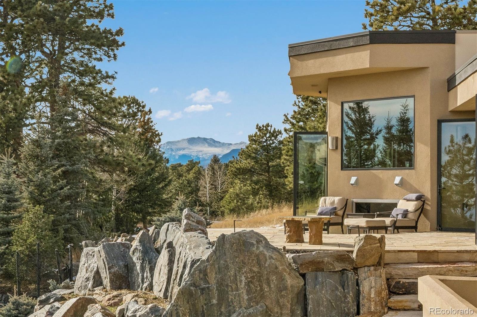 23534 Waynes Way Golden, CO 80401 - Photo 11 of 50 a view of a patio with table and chairs and potted plants