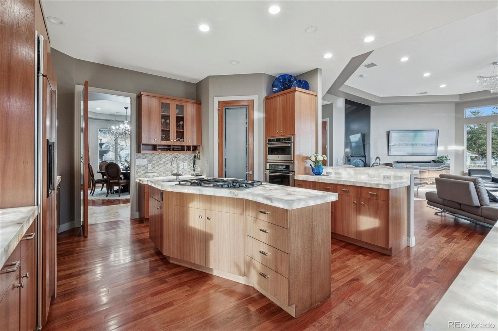 23534 Waynes Way Golden, CO 80401 - Photo 12 of 50 a kitchen with stainless steel appliances granite countertop wooden floors and sink