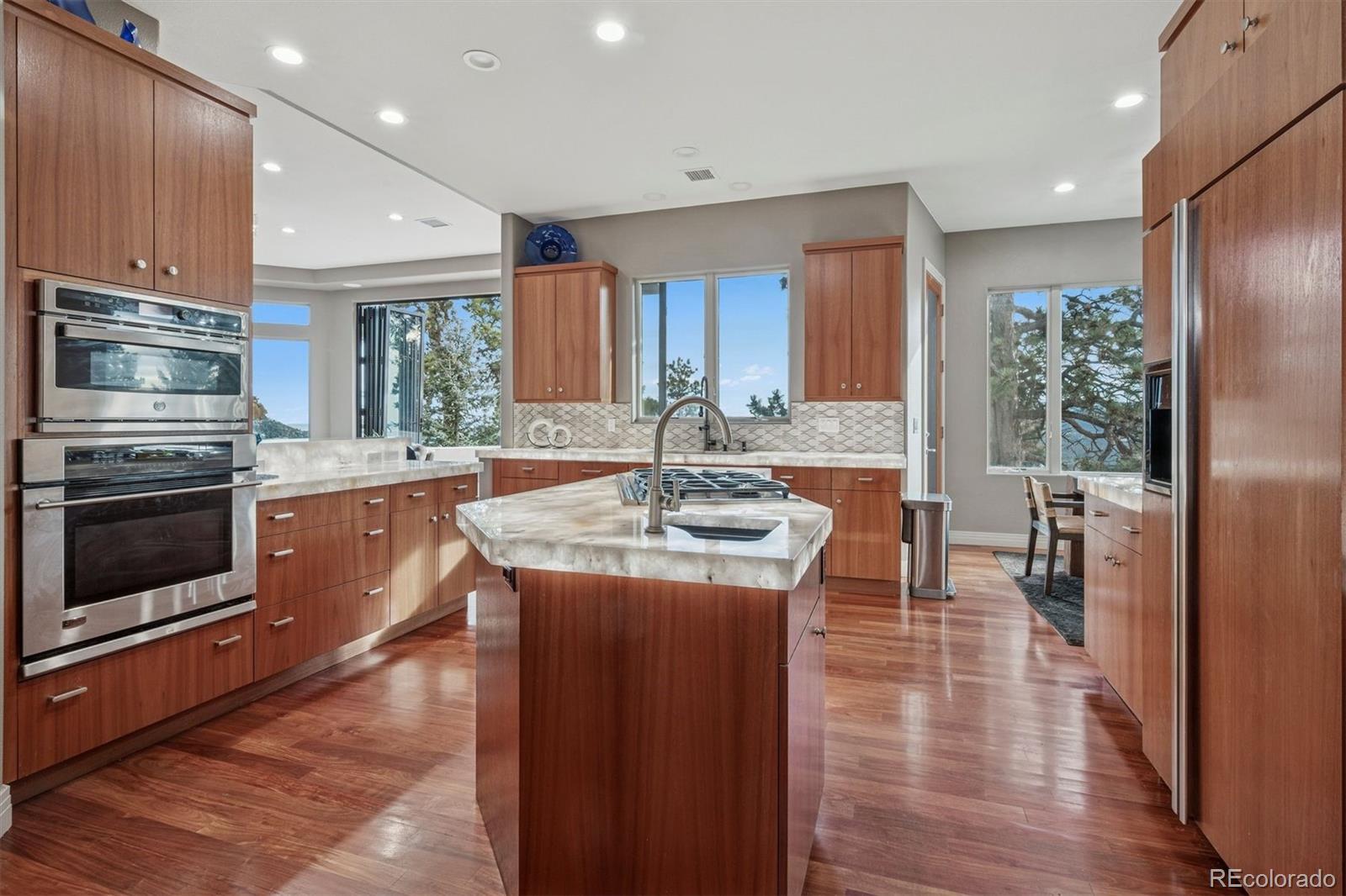 23534 Waynes Way Golden, CO 80401 - Photo 14 of 50 a kitchen with granite countertop a stove a sink and a refrigerator