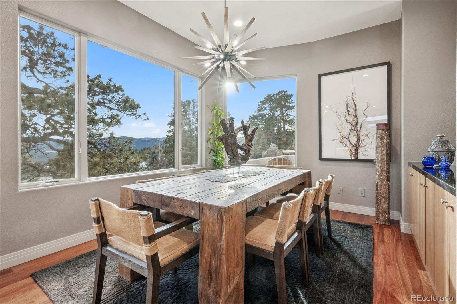 23534 Waynes Way Golden, CO 80401 - Photo 15 of 50 a view of a dining room with furniture window and wooden floor