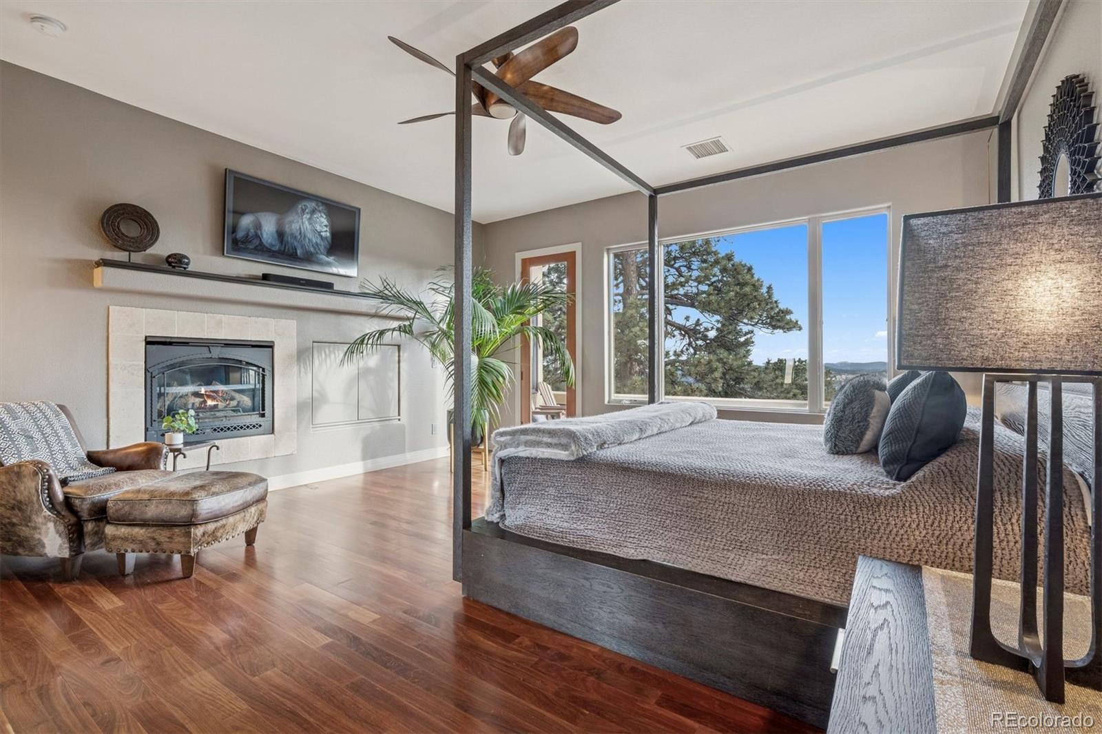 23534 Waynes Way Golden, CO 80401 - Photo 18 of 50 a bedroom with a bed and a fireplace