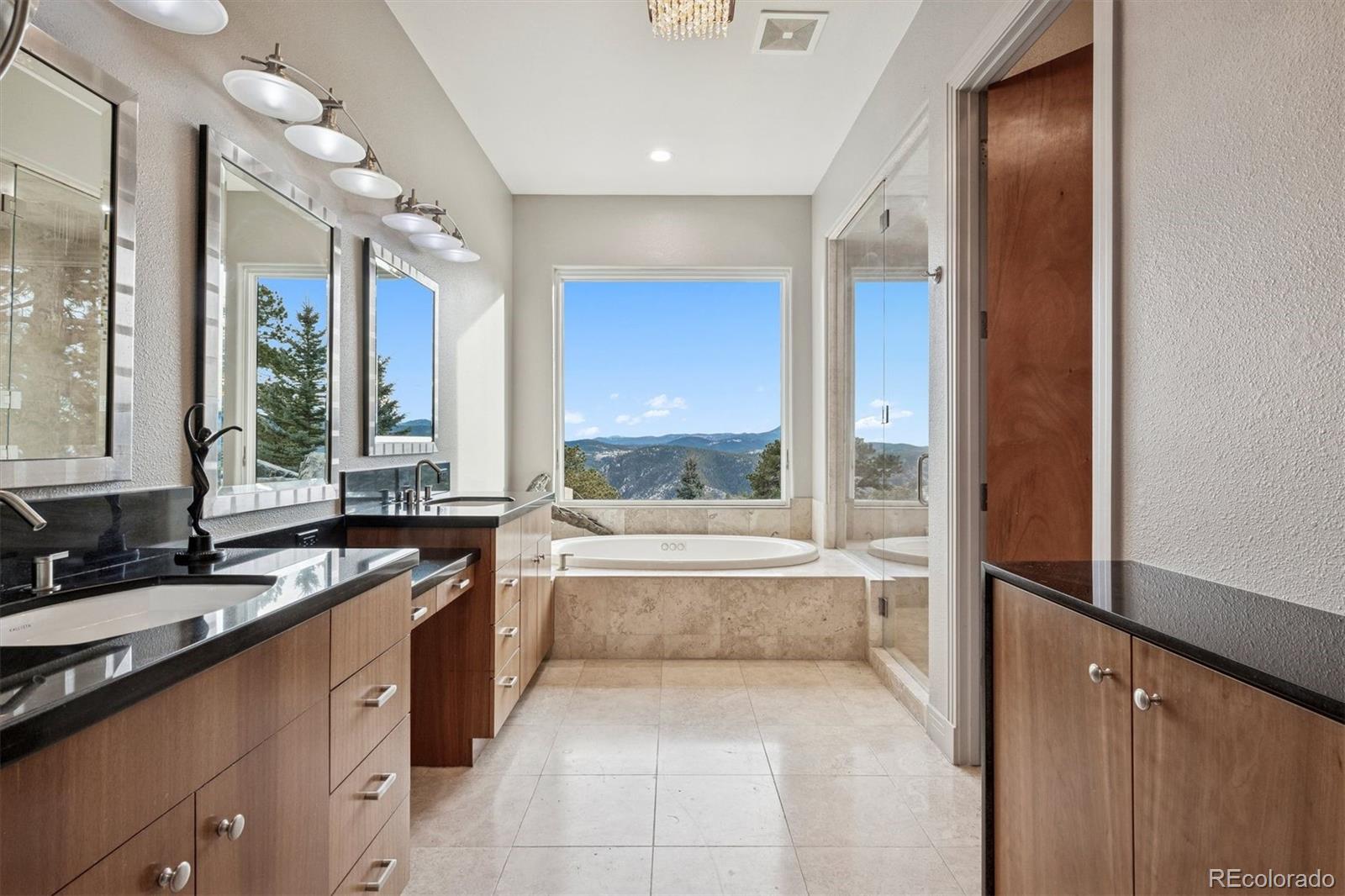23534 Waynes Way Golden, CO 80401 - Photo 22 of 50 a large bathroom with a large tub and sink