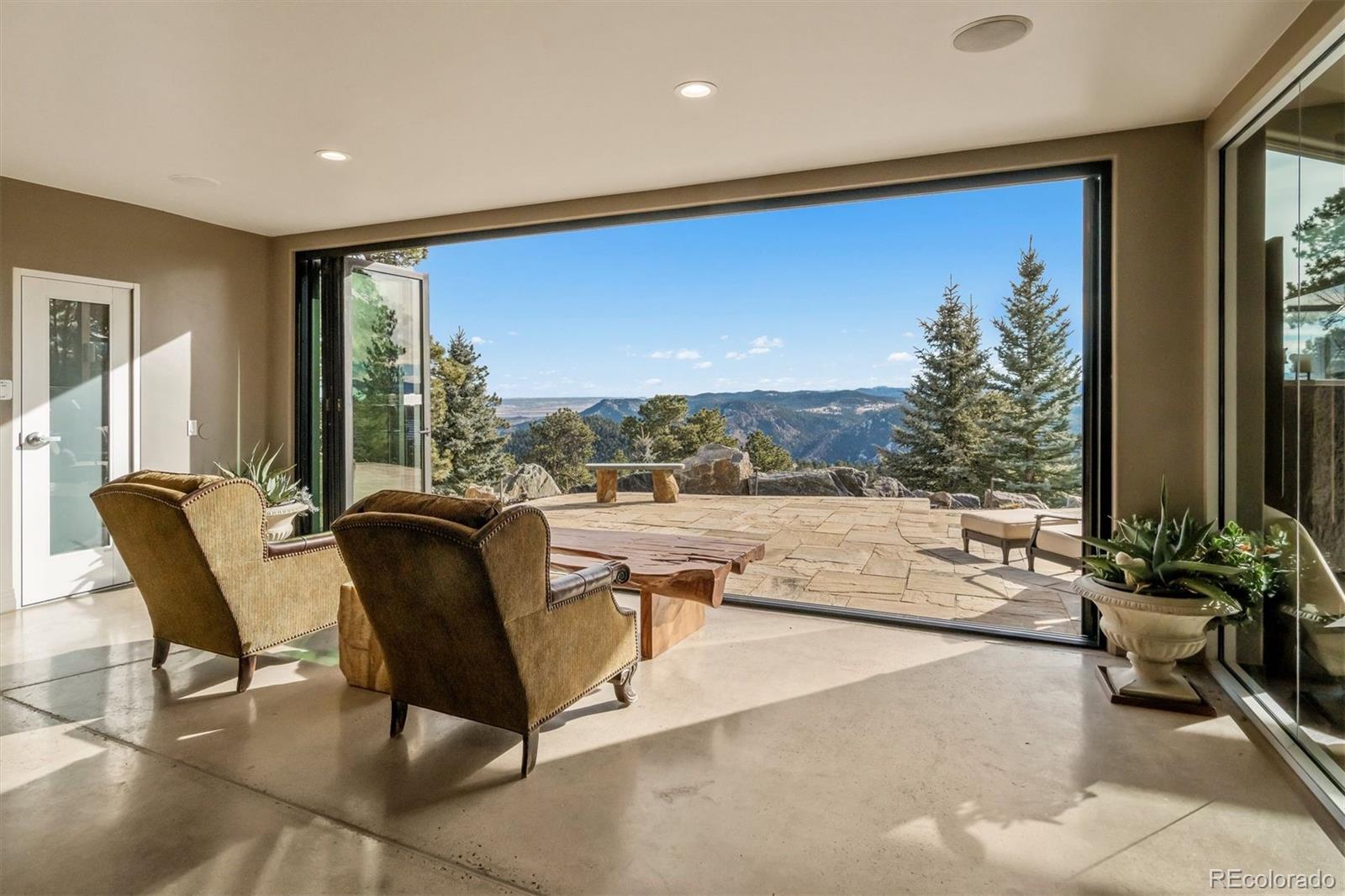 23534 Waynes Way Golden, CO 80401 - Photo 25 of 50 a living room with patio furniture and a floor to ceiling window