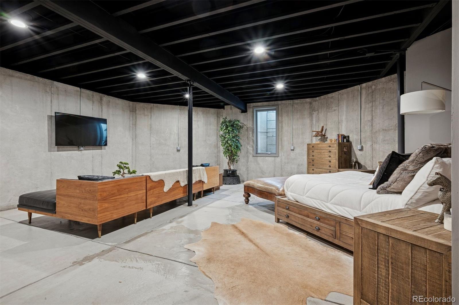 23534 Waynes Way Golden, CO 80401 - Photo 34 of 50 a bed room with a bed and a television