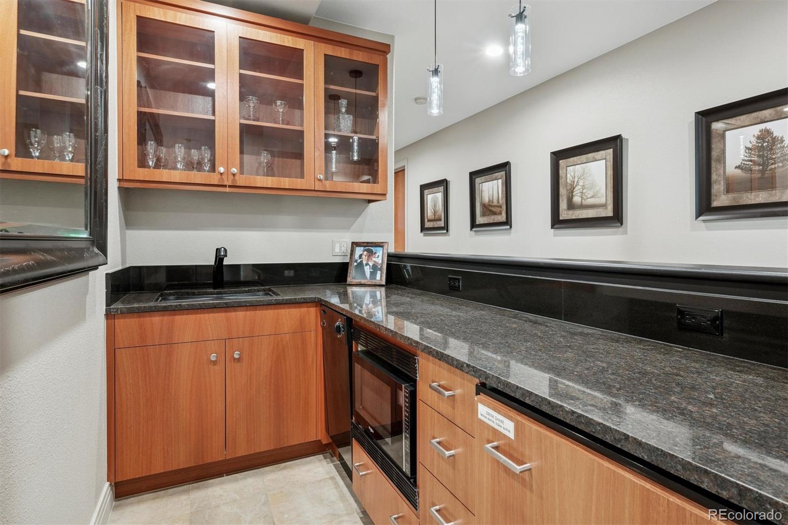 23534 Waynes Way Golden, CO 80401 - Photo 40 of 50 a kitchen with stainless steel appliances granite countertop a sink and a granite counter tops