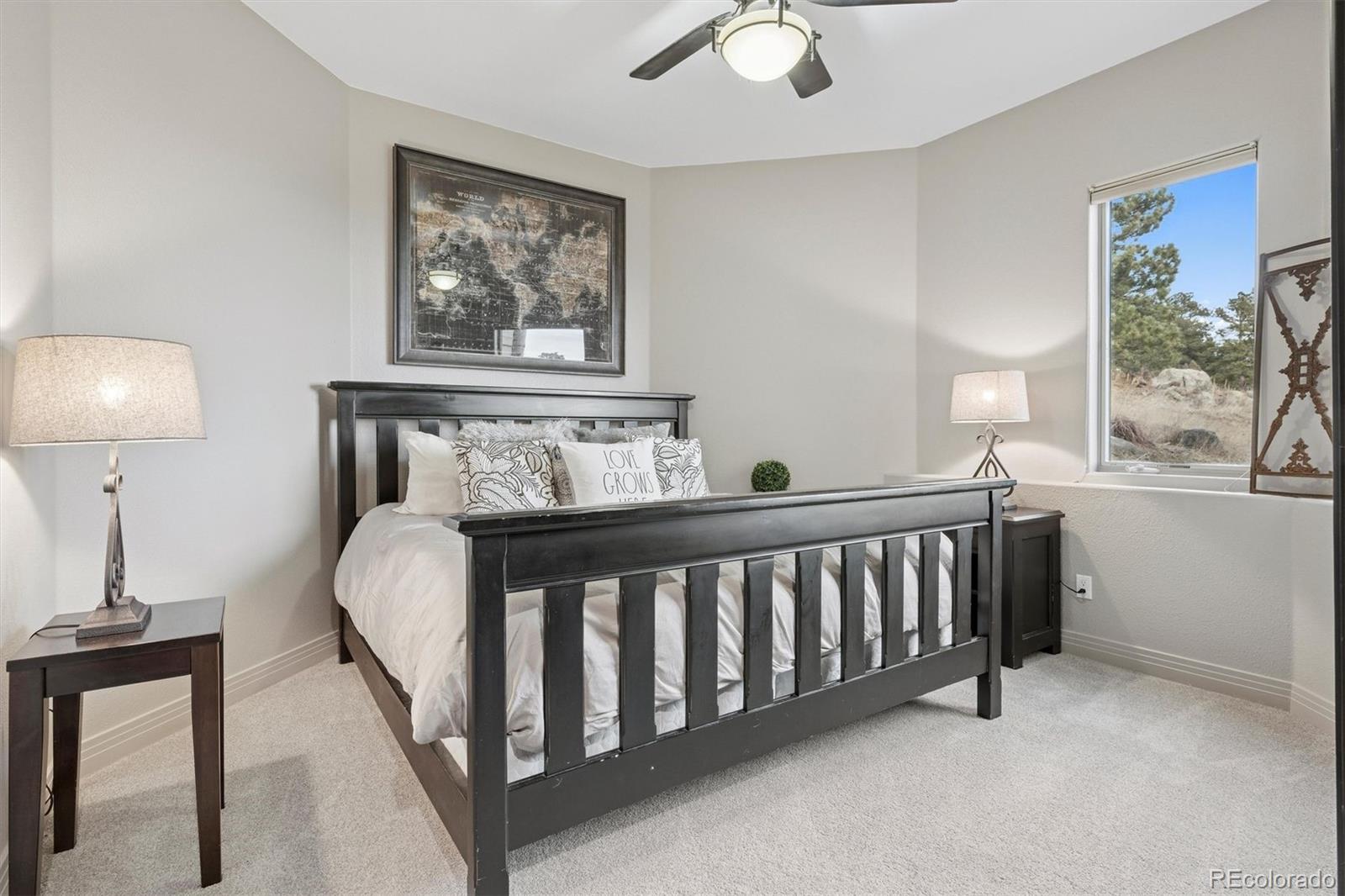 23534 Waynes Way Golden, CO 80401 - Photo 44 of 50 a bed sitting in a bedroom next to a window