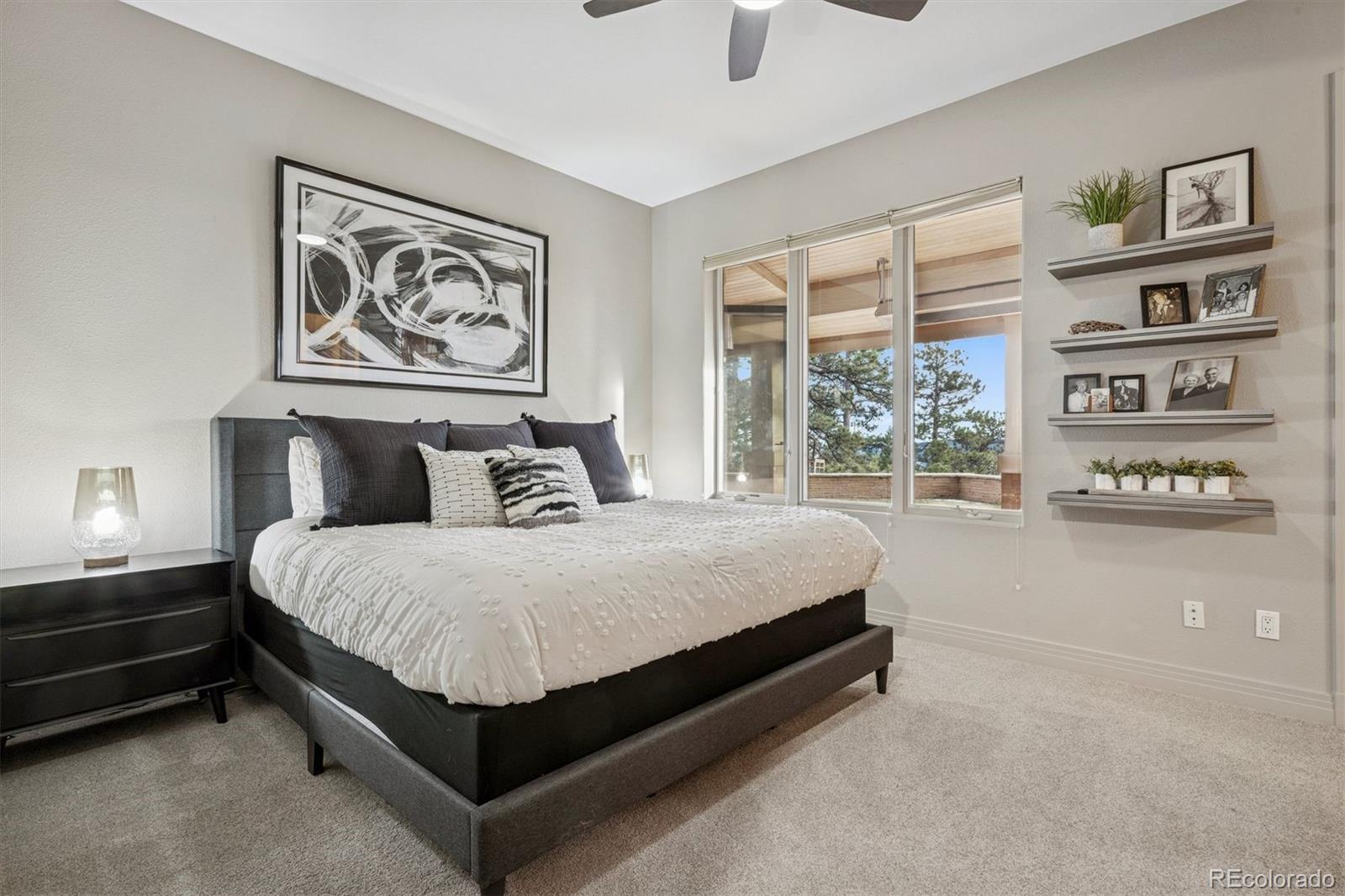23534 Waynes Way Golden, CO 80401 - Photo 46 of 50 a spacious bedroom with a bed and glass window
