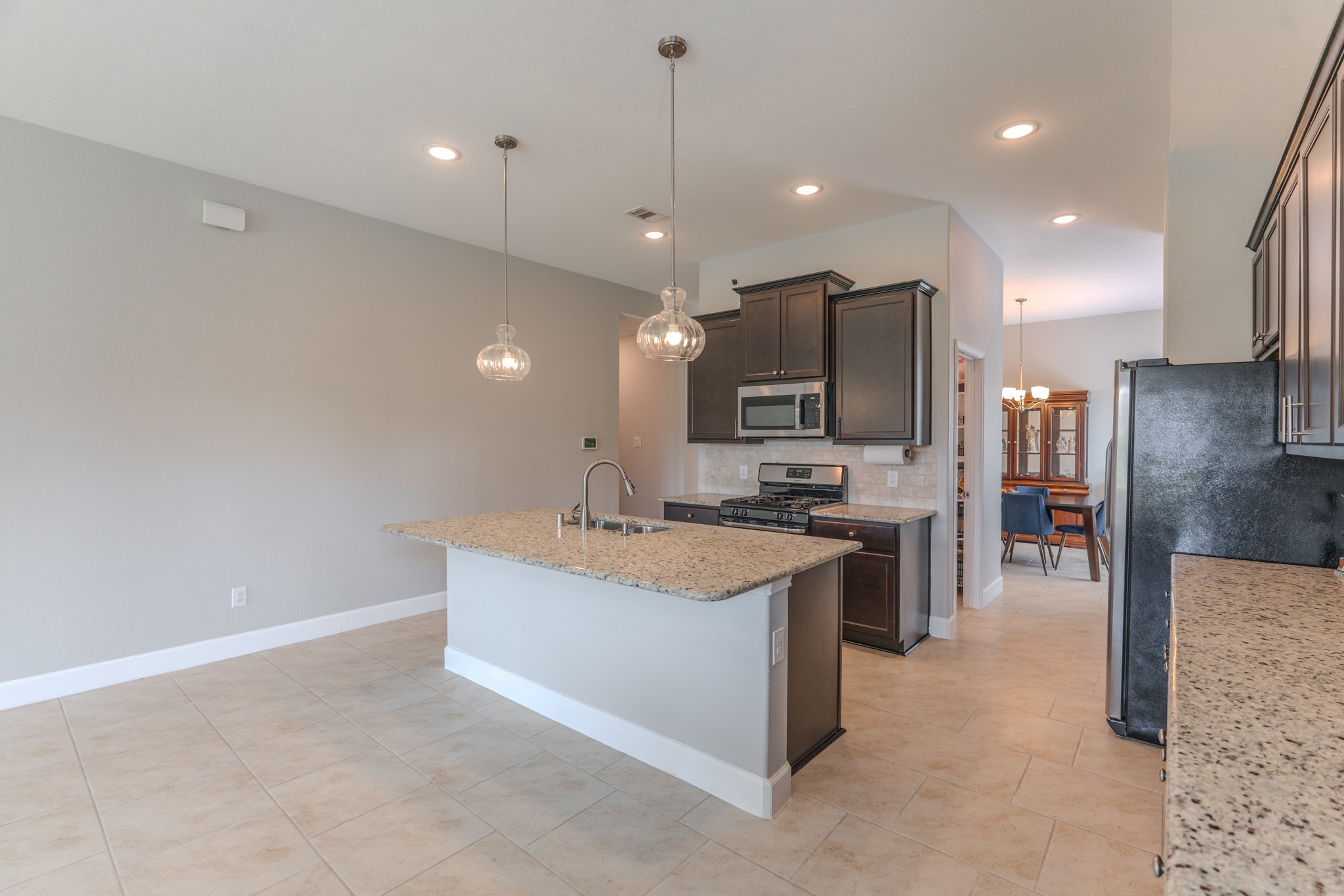 24322 North Newcastle Bay Trail Spring, TX 77389 - Photo 17 of 50 a large kitchen with a large counter top appliances and cabinets
