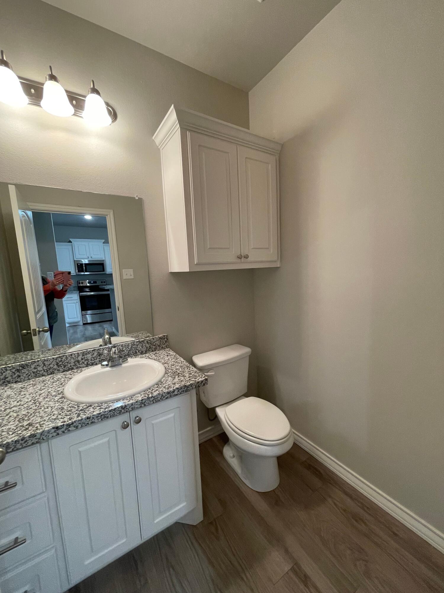 6040 24th Street, Unit 39 Lubbock, TX 79407 - Photo 2 of 13 a bathroom with a granite countertop toilet and a sink