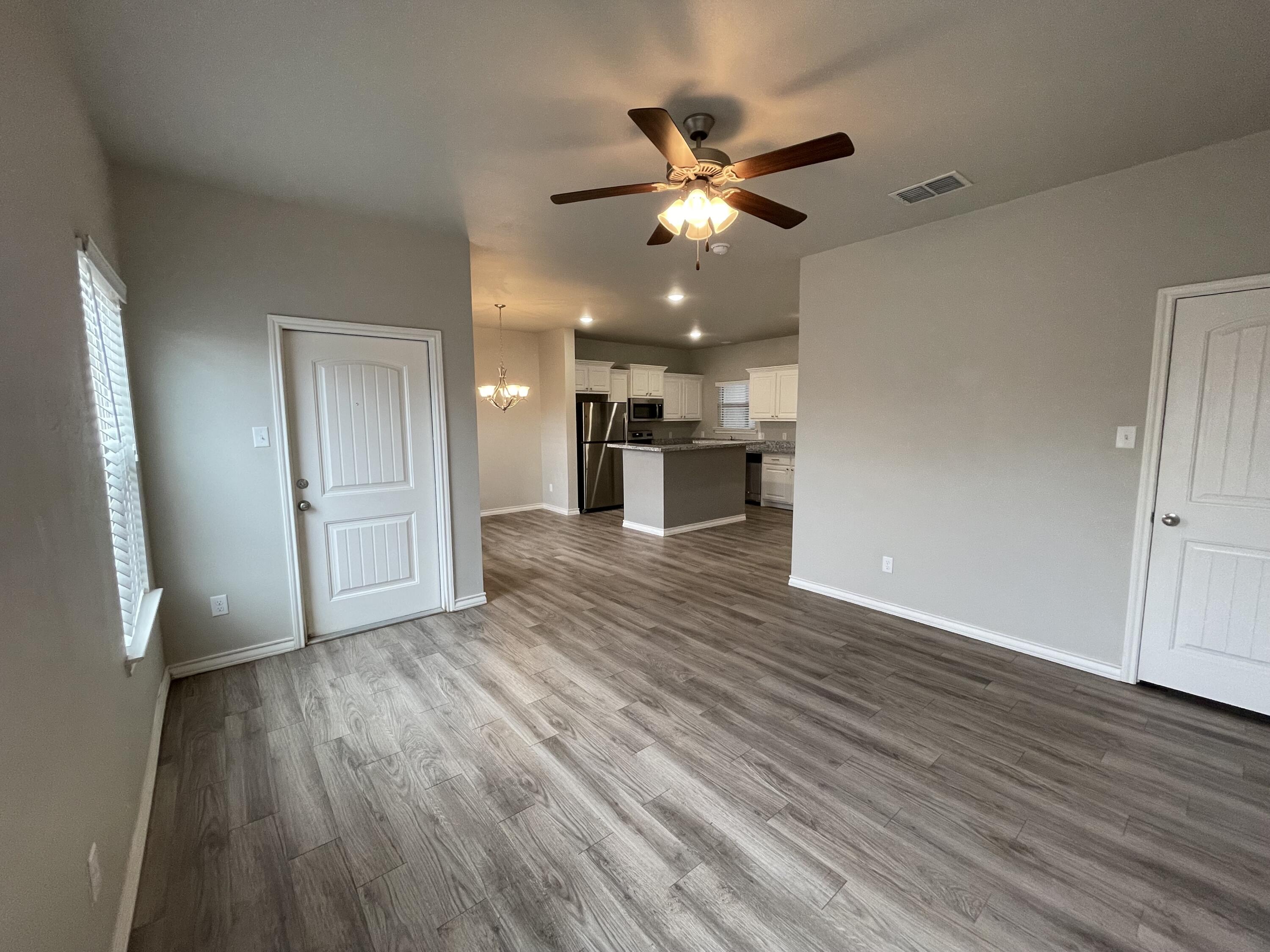 6040 24th Street, Unit 39 Lubbock, TX 79407 - Photo 4 of 13 a view of a kitchen with a sink and microwave