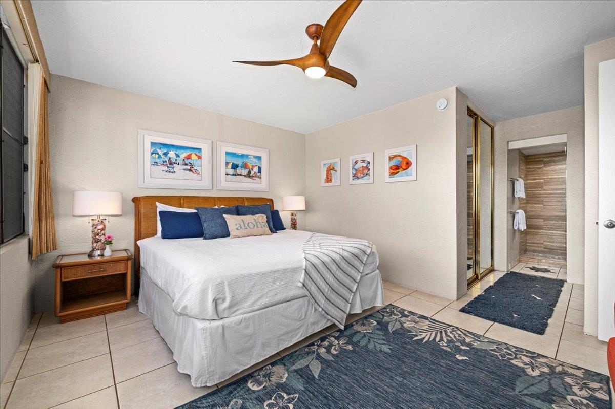 3543 Lower Honoapiilani Road, Unit J302 Lahaina, HI 96761 - Photo 12 of 44 a bedroom with a bed and a window