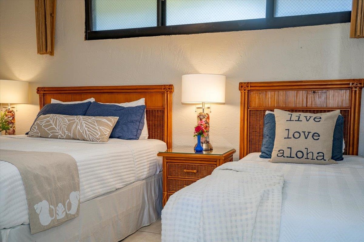 3543 Lower Honoapiilani Road, Unit J302 Lahaina, HI 96761 - Photo 18 of 44 a bedroom with a bed and a painting on the wall
