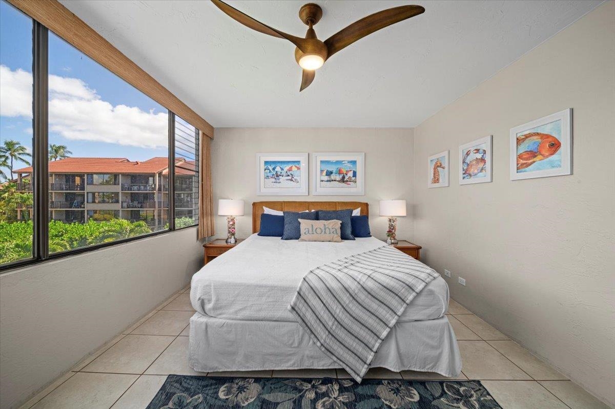 3543 Lower Honoapiilani Road, Unit J302 Lahaina, HI 96761 - Photo 25 of 44 a bedroom with a bed and a large window