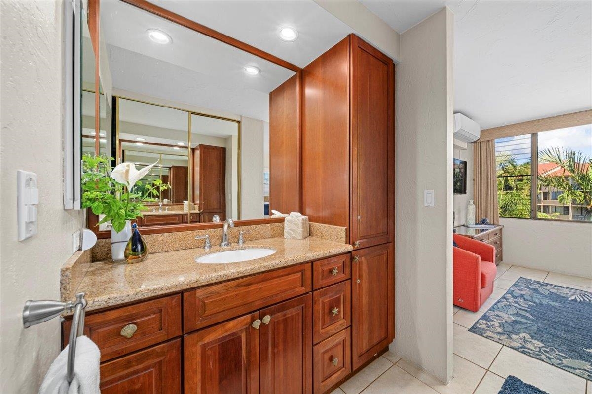 3543 Lower Honoapiilani Road, Unit J302 Lahaina, HI 96761 - Photo 26 of 44 a bathroom with a granite countertop sink and a mirror
