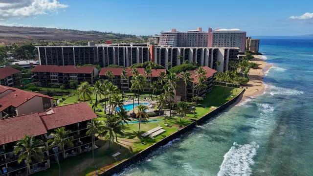 a dining room filled chandelier and kitchen view