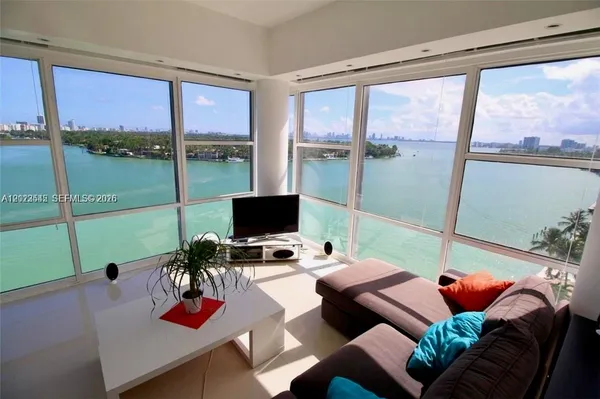 a living room with furniture and a floor to ceiling window