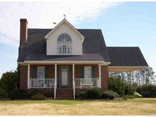 3793 Sheep Pasture Road Spring Hope, NC 27882 - Photo 1 of 1 a front view of a house with garden