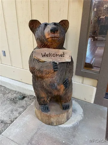 a living room with patio furniture and a chandelier