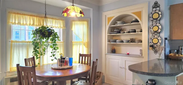 a view of a dining room with furniture window and outside view