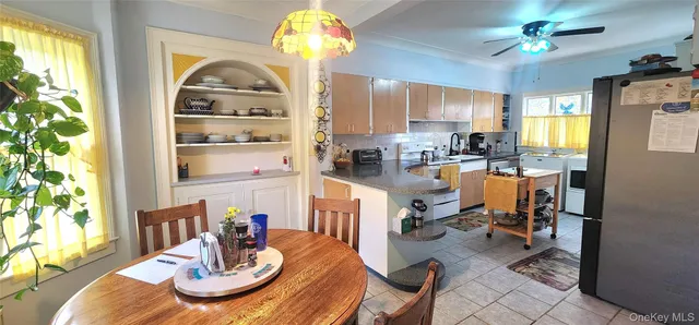 a view of a dining room with furniture a chandelier and wooden floor