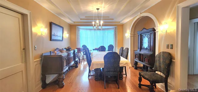 a view of a dining room with furniture and chandelier