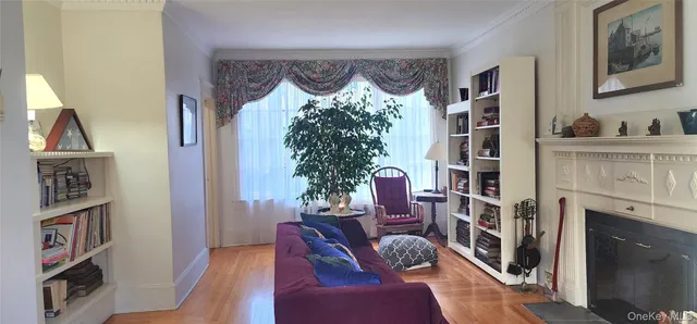 a living room with furniture and a book shelf