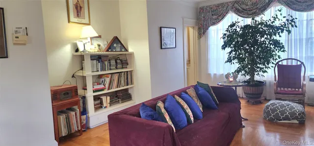 a living room with furniture and a book shelf