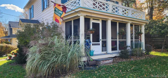 a view of a house with a large window and yard
