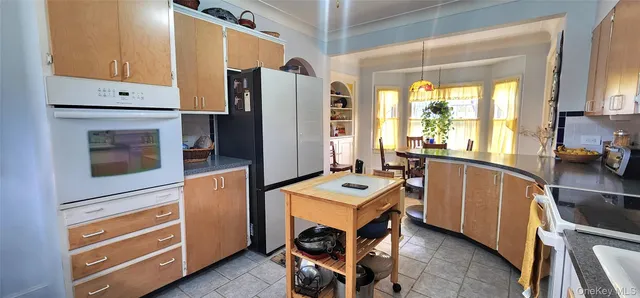 a kitchen with stainless steel appliances a stove a refrigerator and a cabinets