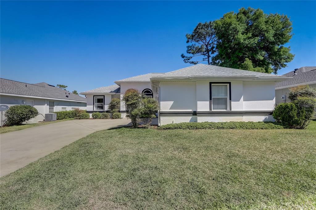 11287 Southwest 73rd Circle Ocala, FL 34476 - Photo 1 of 1 a front view of a house with garden