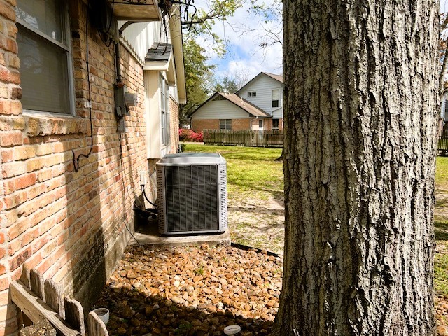 8639 Cedarbrake Drive Spring Valley Village, TX 77055 - Photo 19 of 26 This charming home boasts efficient climate control with a sleek A/C unit discreetly positioned on the side, ensuring comfort and style in a serene backyard setting.