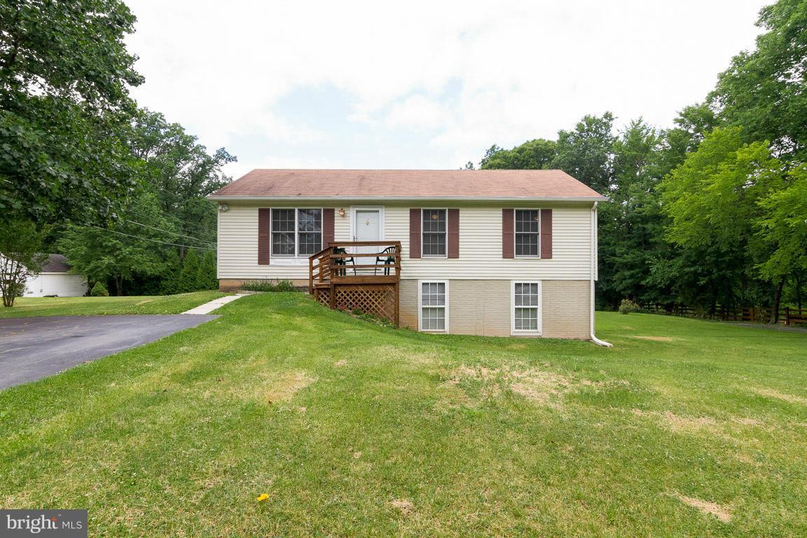 18310 Cattail Road Poolesville, MD 20837 - Photo 1 of 24 a front view of a house with a garden