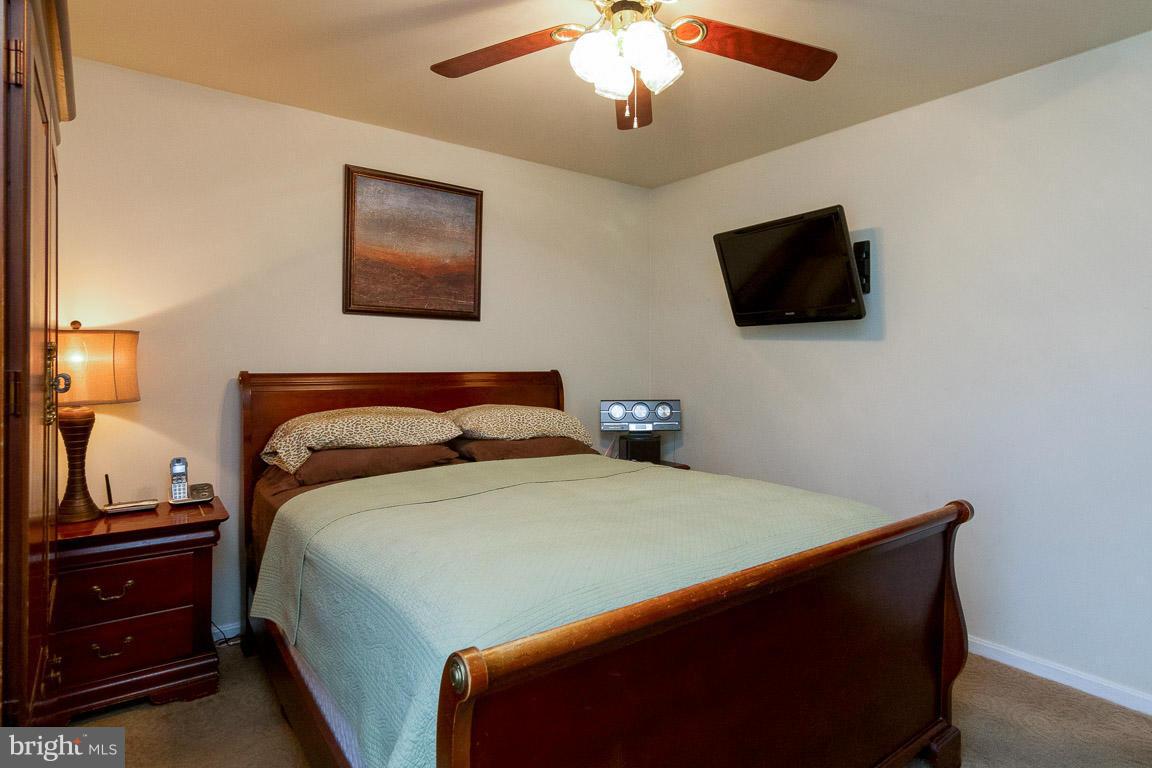 18310 Cattail Road Poolesville, MD 20837 - Photo 12 of 24 a bedroom with a bed and a flat screen tv