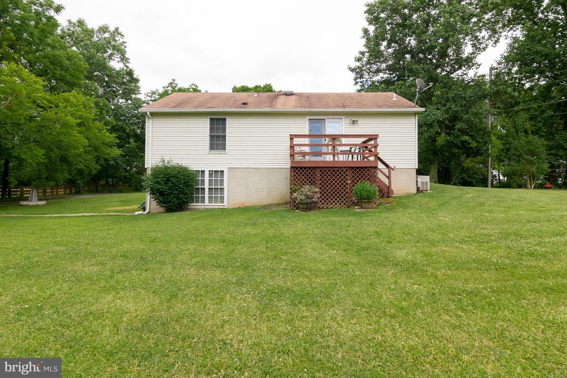 18310 Cattail Road Poolesville, MD 20837 - Photo 22 of 24 a front view of a house with yard and garage