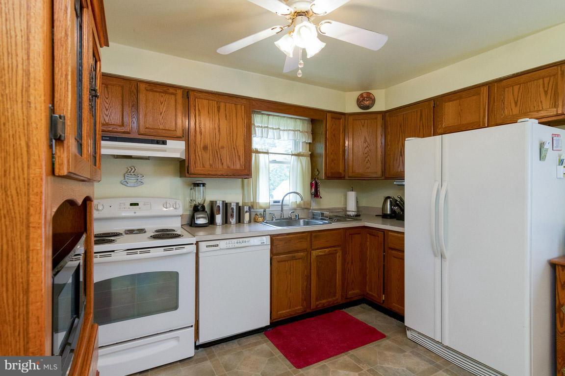 18310 Cattail Road Poolesville, MD 20837 - Photo 4 of 24 a kitchen with stainless steel appliances granite countertop a refrigerator sink and cabinets