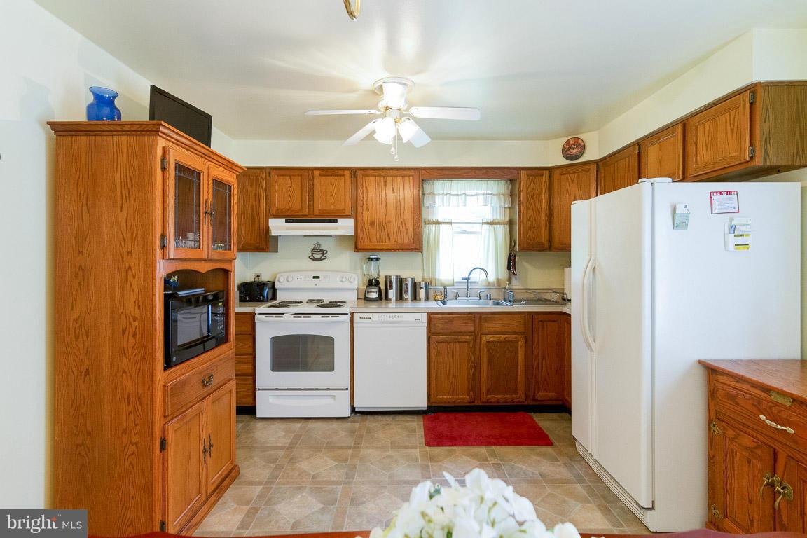 18310 Cattail Road Poolesville, MD 20837 - Photo 6 of 24 a kitchen with granite countertop a refrigerator stove top oven and sink