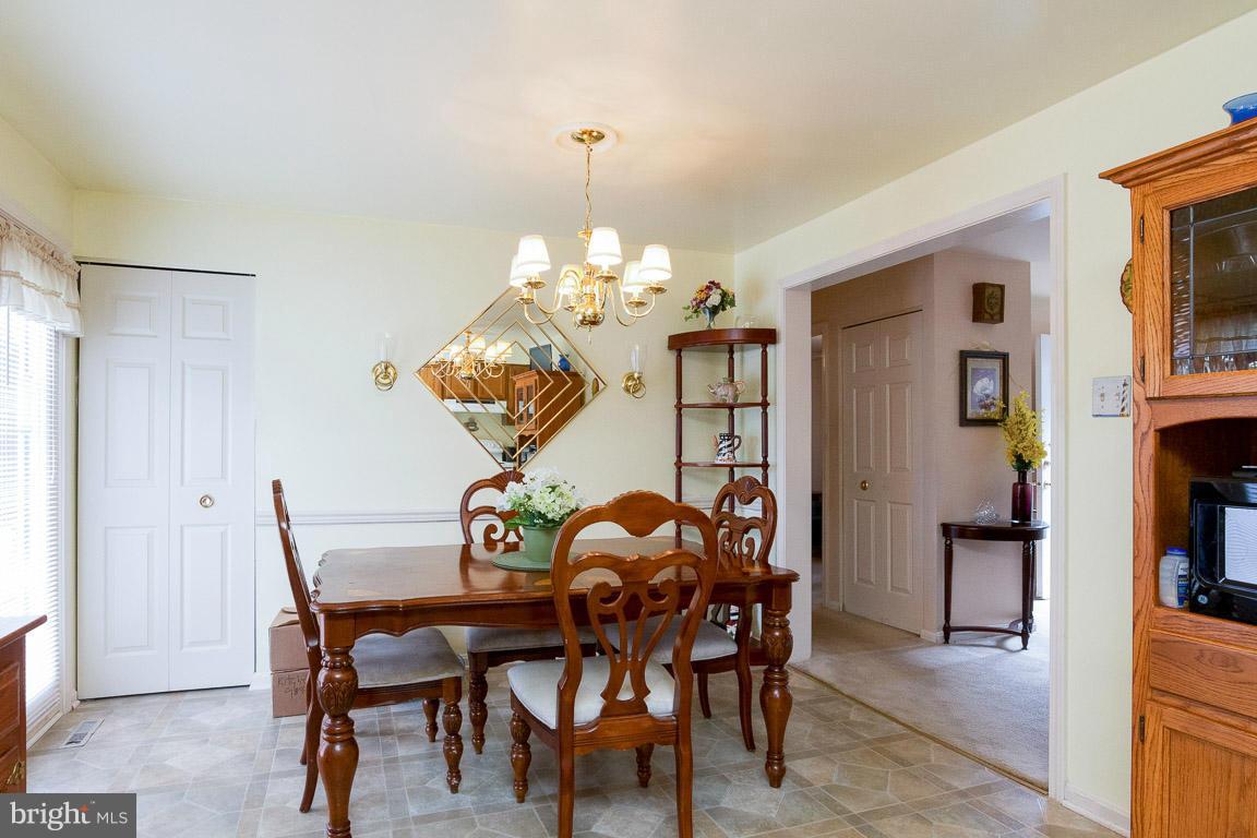 18310 Cattail Road Poolesville, MD 20837 - Photo 8 of 24 a view of a dining room with furniture and chandelier