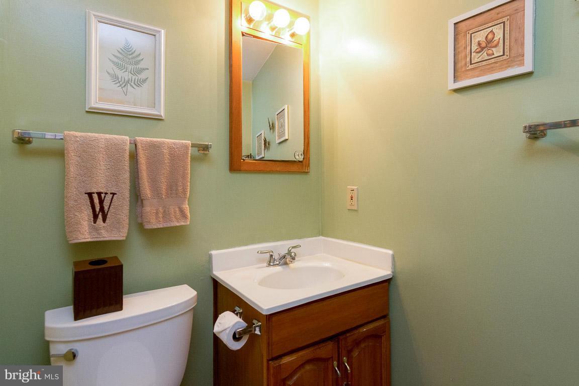 18310 Cattail Road Poolesville, MD 20837 - Photo 10 of 24 a bathroom with a sink mirror and toilet