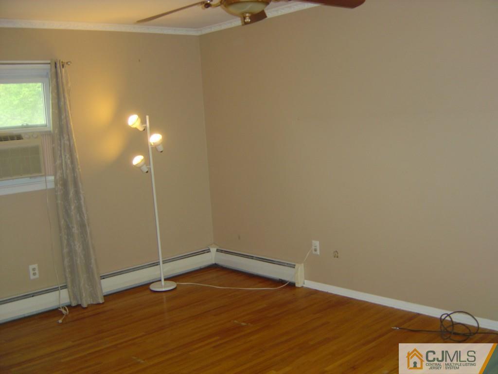 69 Greenbrook Road Middlesex, NJ 08846 - Photo 14 of 24 an empty room with wooden floor and windows
