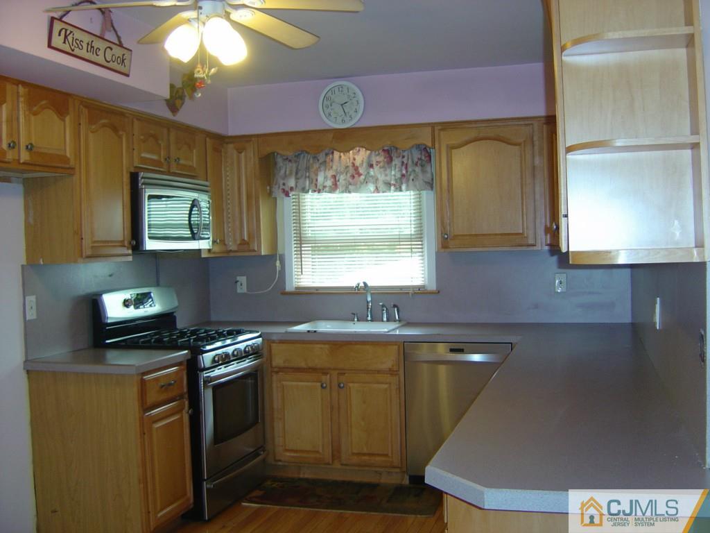 69 Greenbrook Road Middlesex, NJ 08846 - Photo 4 of 24 a kitchen with a sink a stove cabinets and a window