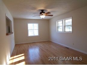 3453 Cold Springs Road Greenville, VA 24440 - Photo 2 of 7 a view of an empty room with wooden floor and a window