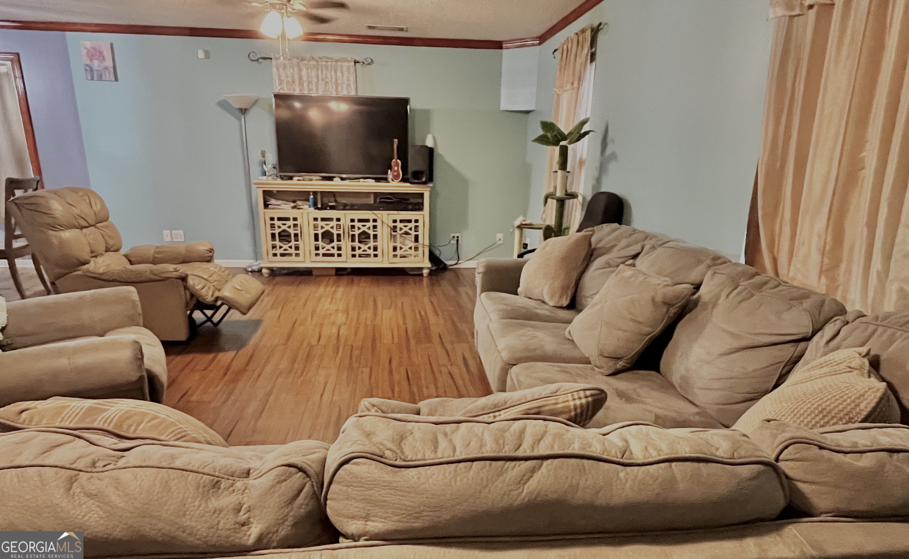 705 Geiger Street Mount Vernon, GA 30445 - Photo 3 of 11 a living room with furniture and a flat screen tv