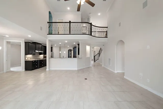 a view of a hallway with dining area and chandelier