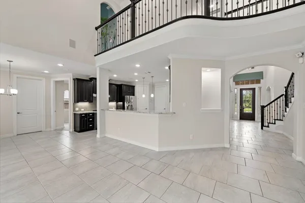 a large kitchen with stainless steel appliances granite countertop a stove a refrigerator and a sink