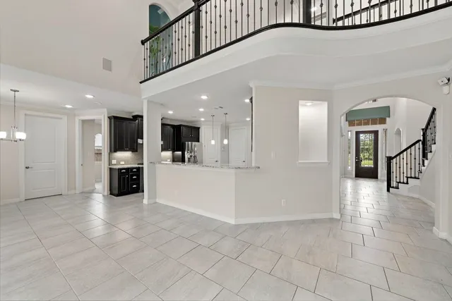 a large kitchen with stainless steel appliances granite countertop a stove a refrigerator and a sink