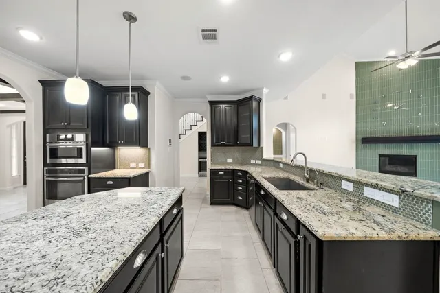 a large kitchen with cabinets and stainless steel appliances