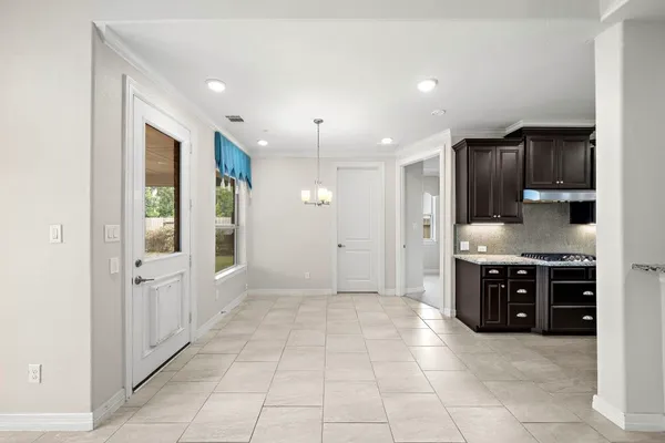 a kitchen with stainless steel appliances kitchen island granite countertop a table and chairs in it