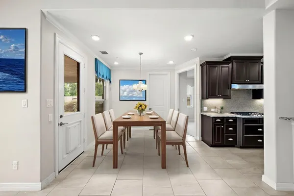 a view of a hallway with furniture and wooden floor
