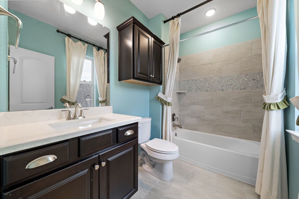3810 Everly Bend Drive Spring, TX 77386 - Photo 31 of 40 a bathroom with a sink a toilet and shower